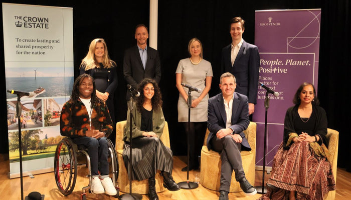 panellists and key stakeholders from the The Crown Estate and Grosvenor smiling together on stage at the Inclusive Places Initiative launch event