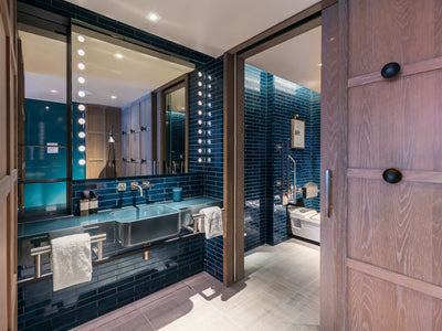 Accessible bathroom with vibrant blue metro tiles at the Londoner