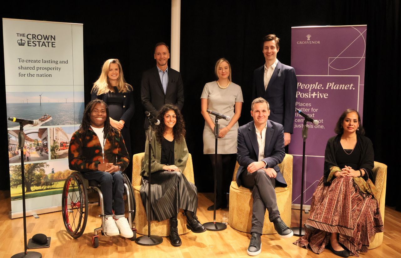 panellists and key stakeholders from the The Crown Estate and Grosvenor smiling together on stage at the Inclusive Places Initiative launch event