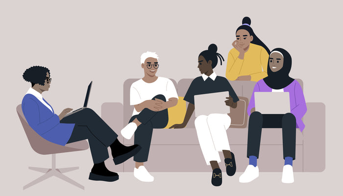 Group of diverse people meeting at work on a sofa