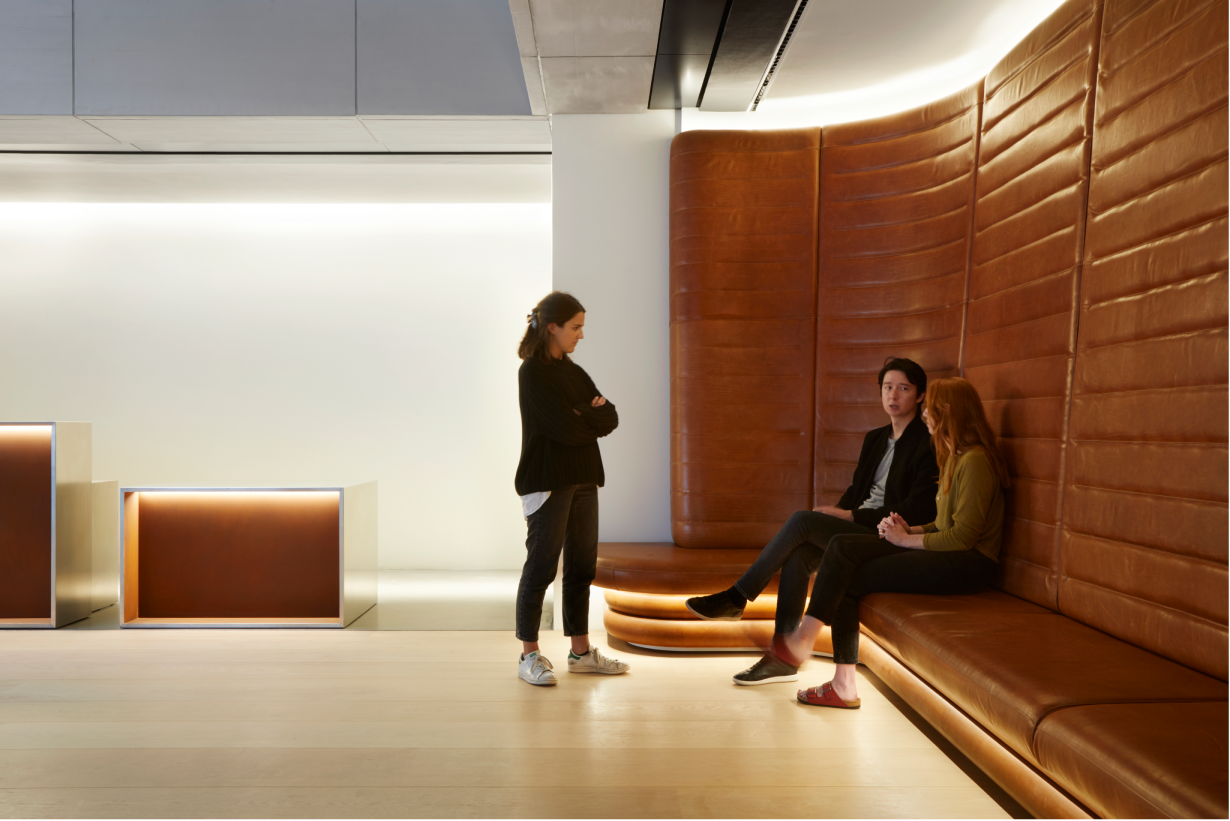 Individuals sat on accessible seating in foyer