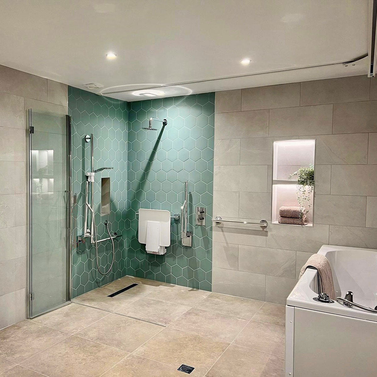 Accessible shower with turquoise hexagonal tiles
