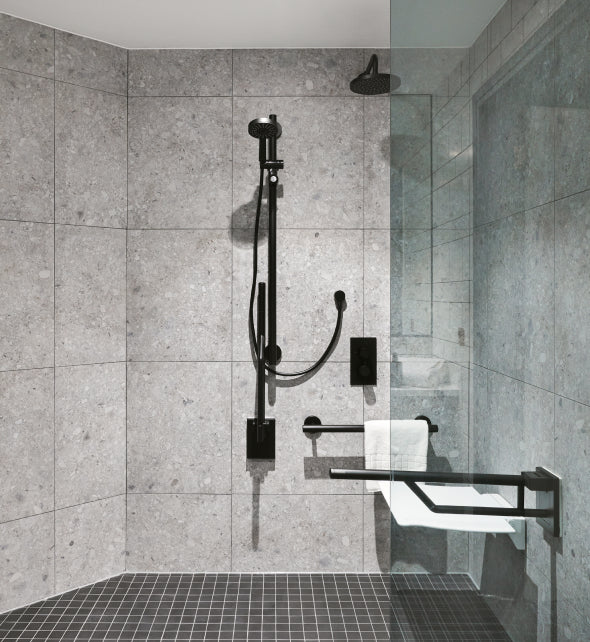 modern accessible shower area with matt black grab rails