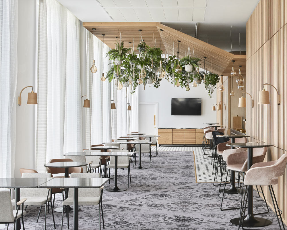 bright accessible dining area featuring natural wood and biophilia elements