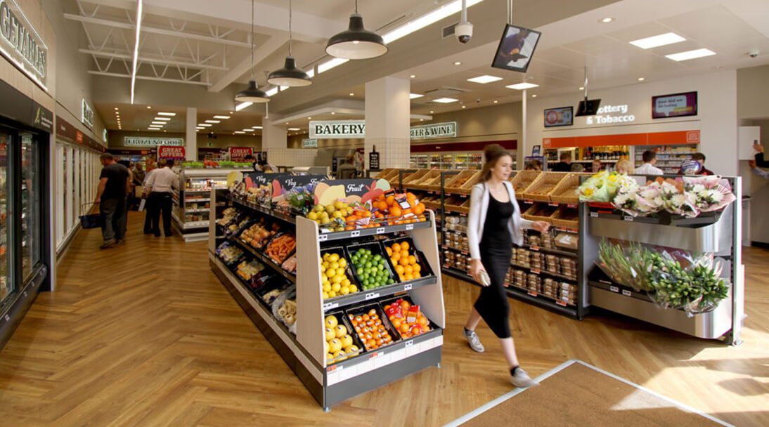 Interior of a store showcasing colour fruit and vegetables with clear signage.